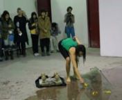 Performed in Guangzhou LIVE 5: International Performance Art Festival . n@ You You Contemporary Art Centre, Guangzhou, China. December 7, 2014. nCurated by Jonas Stampe. nActual TRT 20 minutes. (Translated in Chinese by a festival volunteer.)nnJodie Lyn-Kee-Chow explores themes of migration and multi-cultural identities in this work.With an endurance and site-specific based performance practice, the artist performs throughout the gallery space bearing flags of her ancestry – Jamaica and Chin