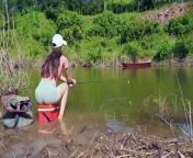 Beautiful Girl Catches a fish originating from the Amazon Forest