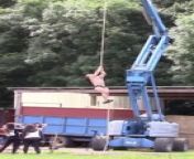 Huge bodybuilder falls from a rope from muscle bodybuilder dominant