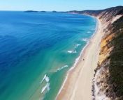 Drone view of a vehicle on rainbow beach from girl xxx blue