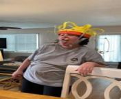 This woman was celebrating her birthday with her family by playing a new game they bought. The woman wore the game hat with food items dangling in front of her face and spun around her head. As the game&#39;s objective was to grab the food without using hands, the woman made silly faces causing her family to burst out laughing and unable to breathe.